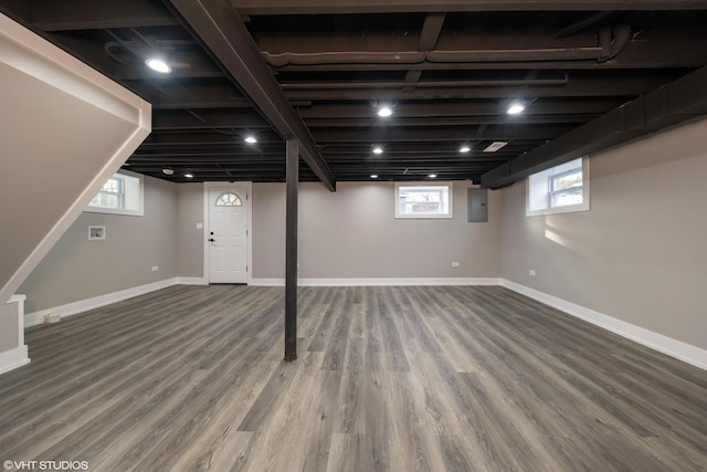 basement with wood-type flooring and electric panel