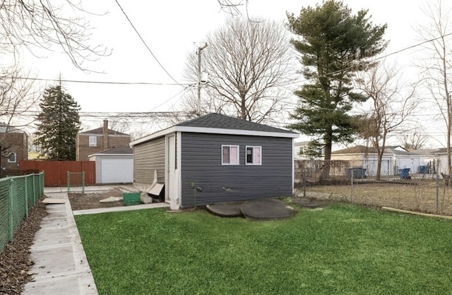 exterior space featuring an outbuilding, a yard, and a garage