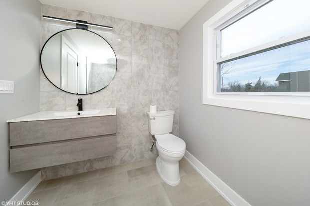 bathroom featuring vanity, toilet, and tile patterned flooring