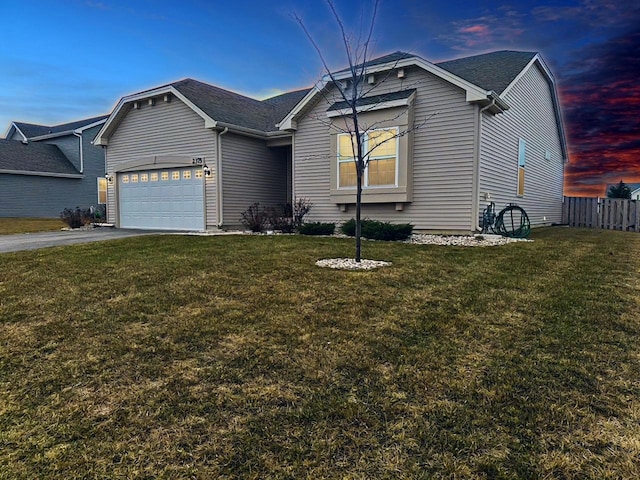 view of front facade featuring a garage and a yard