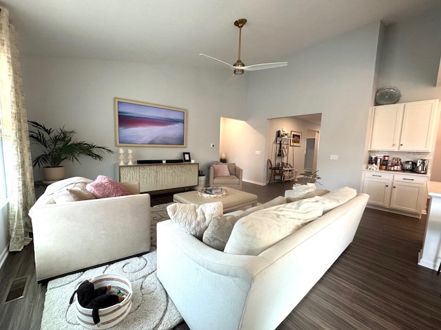 living room featuring high vaulted ceiling, dark hardwood / wood-style floors, and ceiling fan