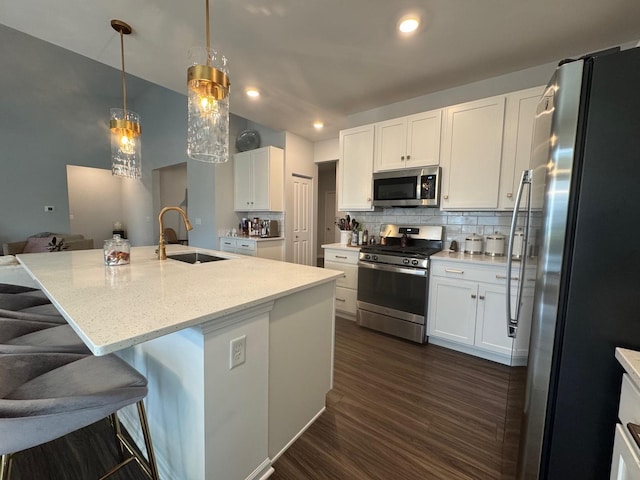 kitchen featuring white cabinetry, sink, a kitchen island with sink, and appliances with stainless steel finishes