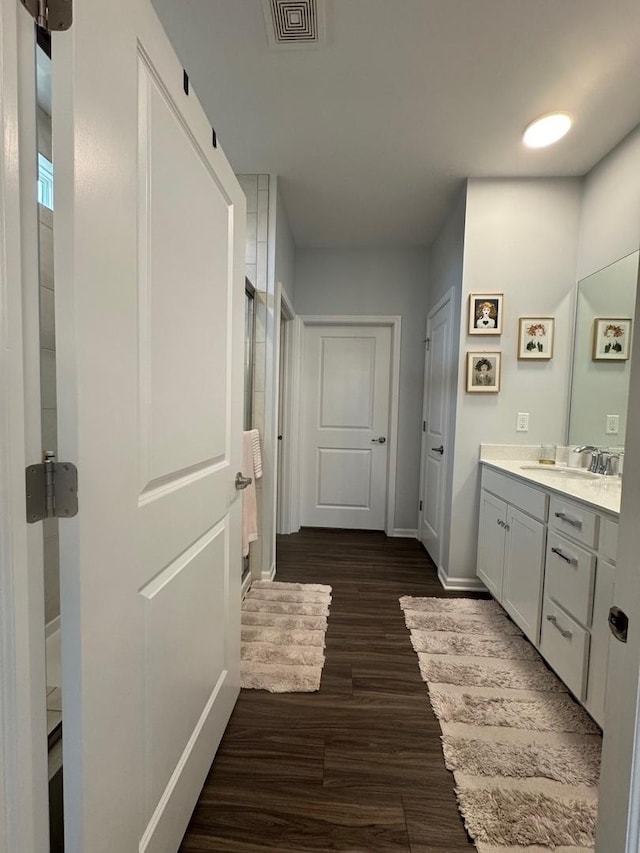 bathroom with vanity and hardwood / wood-style floors