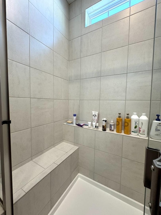 bathroom with tiled shower