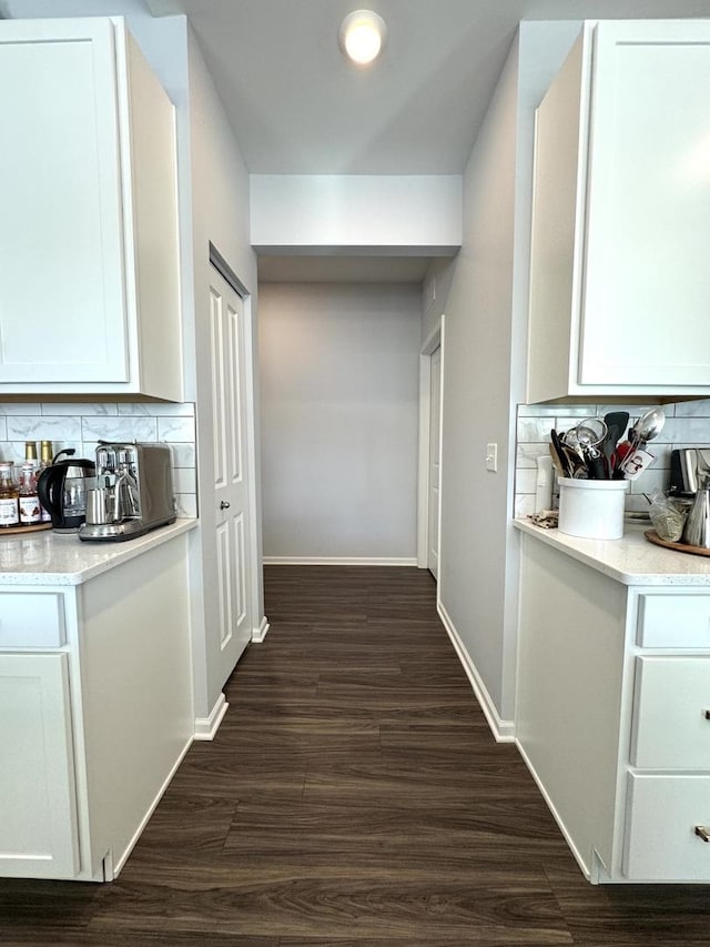 hallway with dark wood-type flooring