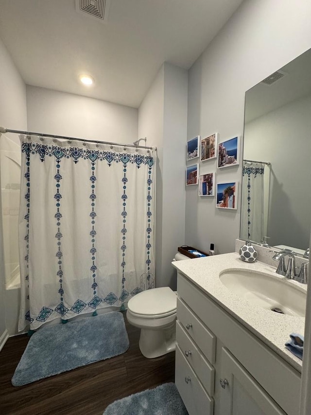 bathroom with vanity, hardwood / wood-style floors, and toilet