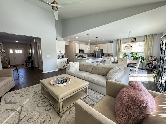 living room featuring ceiling fan, hardwood / wood-style floors, and high vaulted ceiling