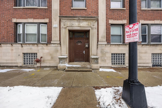 view of snow covered property entrance