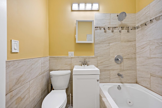 bathroom featuring tile walls, a tub to relax in, vanity, and toilet