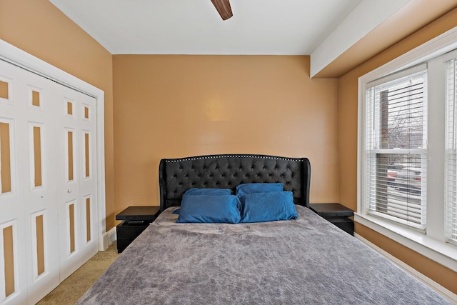 carpeted bedroom featuring a closet and ceiling fan