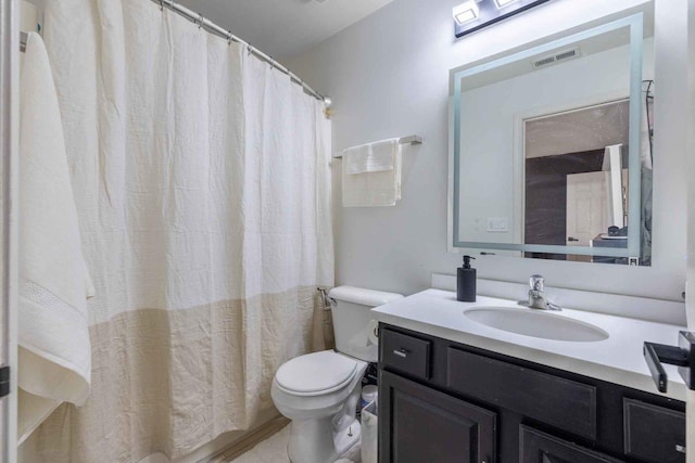 bathroom with toilet and vanity