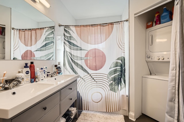 bathroom with shower / bath combo with shower curtain, stacked washer / dryer, and vanity