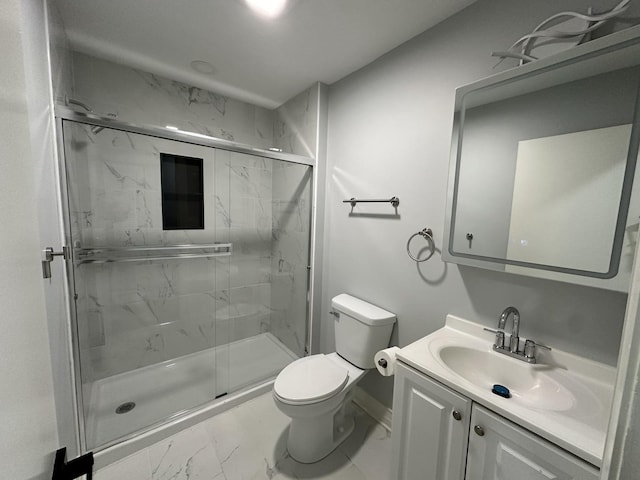 full bath featuring a marble finish shower, toilet, marble finish floor, and vanity