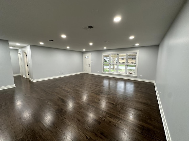 empty room with dark wood-type flooring