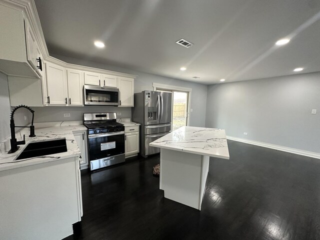 kitchen with a kitchen island, sink, dark hardwood / wood-style flooring, and white cabinetry