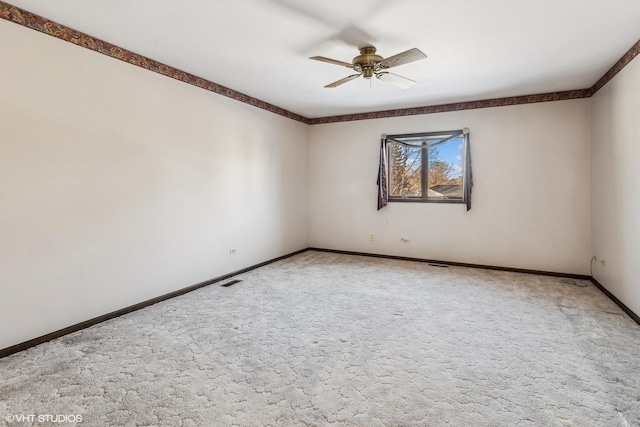 carpeted empty room featuring ceiling fan