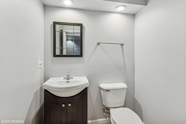 bathroom featuring toilet and vanity