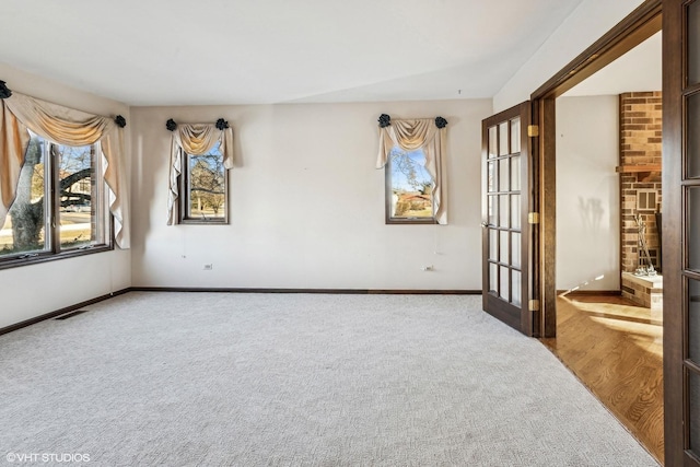 carpeted spare room with french doors