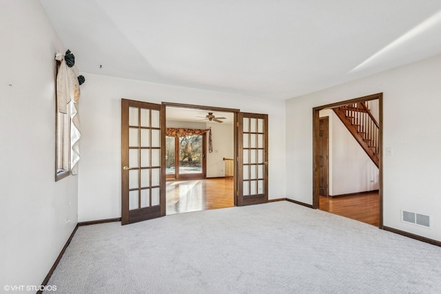 carpeted spare room featuring ceiling fan, french doors, and radiator