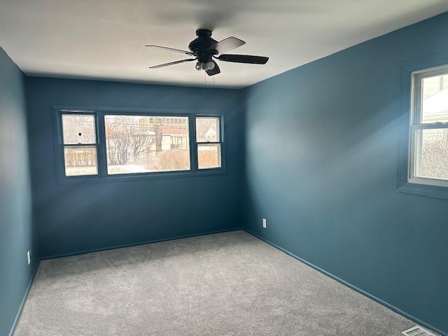 unfurnished room with ceiling fan and carpet floors