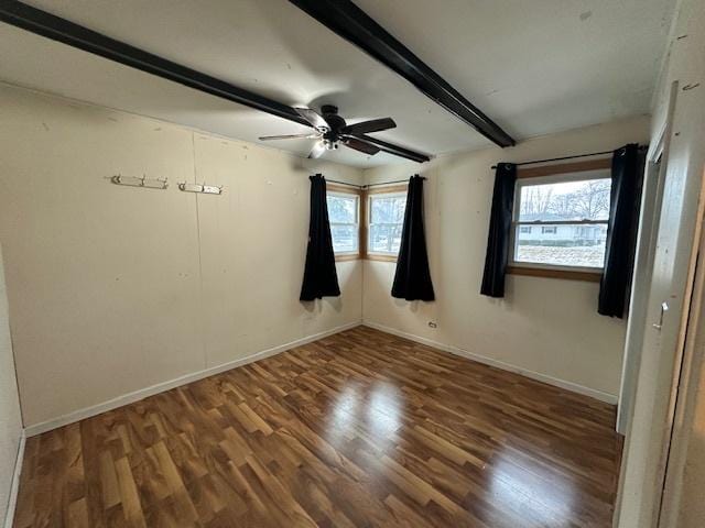 spare room with ceiling fan, beamed ceiling, and dark hardwood / wood-style floors