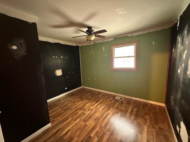 spare room featuring ceiling fan and hardwood / wood-style floors