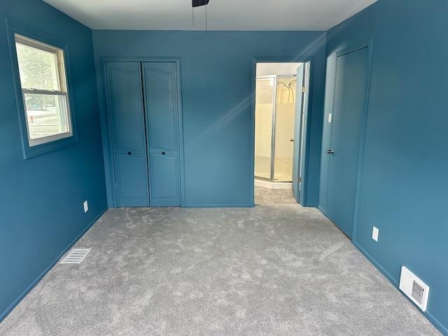 unfurnished bedroom featuring ceiling fan and carpet floors