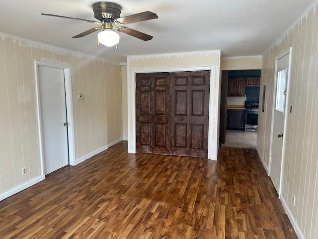 unfurnished bedroom featuring ceiling fan, dark wood-type flooring, and a closet