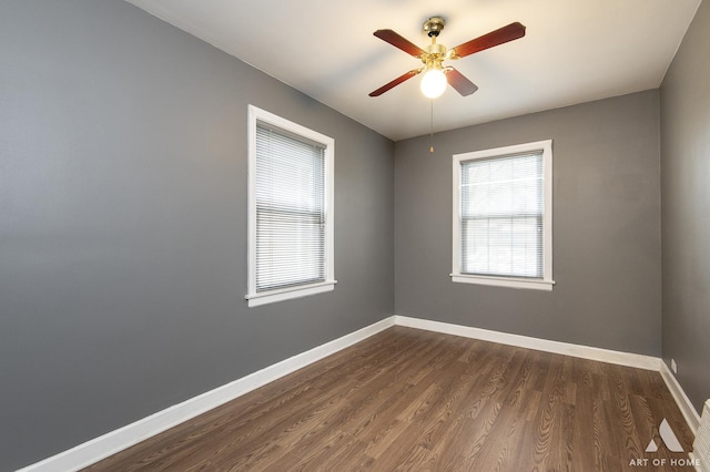 unfurnished room with ceiling fan and dark wood-type flooring