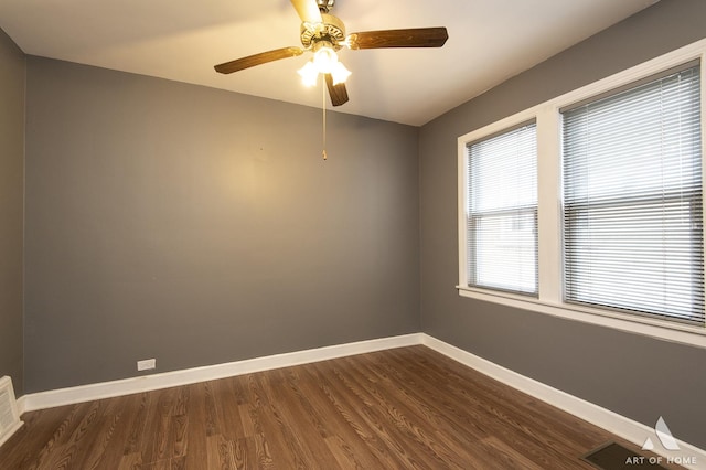 spare room with ceiling fan and dark wood-type flooring