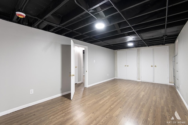 basement with hardwood / wood-style flooring