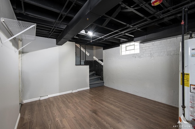 basement featuring gas water heater and dark wood-type flooring