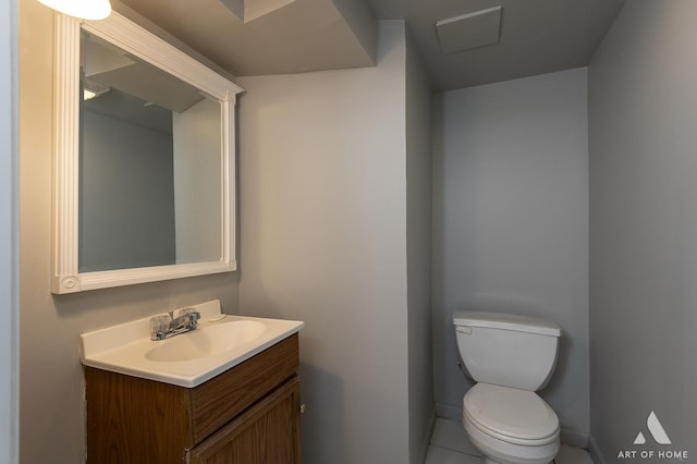 bathroom with tile patterned flooring, vanity, and toilet