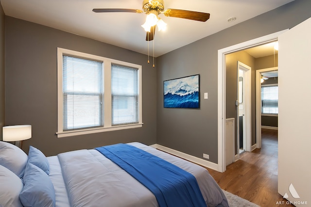 bedroom with hardwood / wood-style floors and ceiling fan