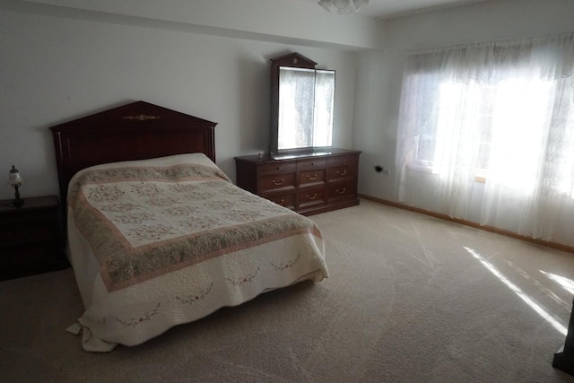 carpeted bedroom with multiple windows