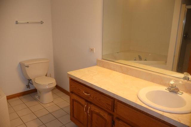 full bathroom featuring a tub to relax in, baseboards, toilet, tile patterned flooring, and vanity