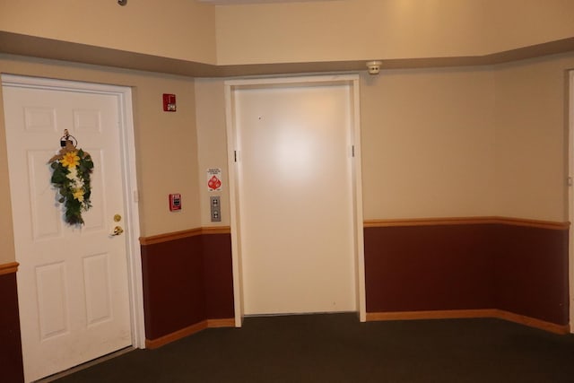 entryway featuring baseboards and elevator