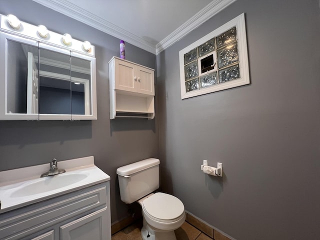 bathroom featuring toilet, vanity, ornamental molding, and tile patterned flooring