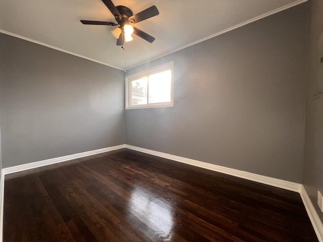 empty room featuring ceiling fan, dark wood-type flooring, and crown molding