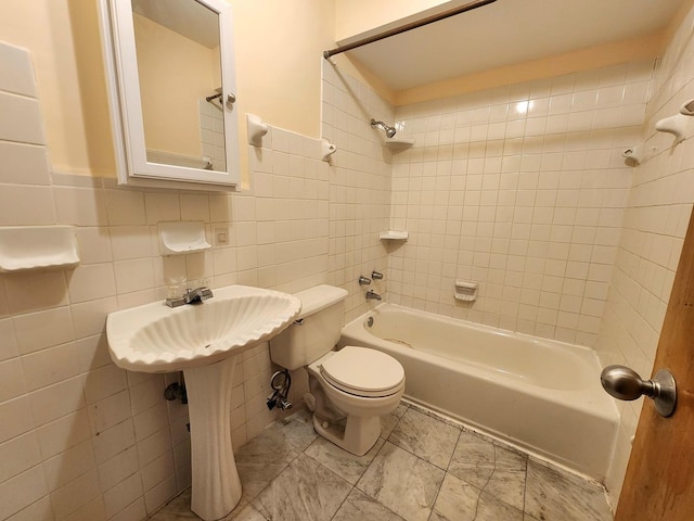 bathroom featuring tile walls, toilet, and shower / bathtub combination