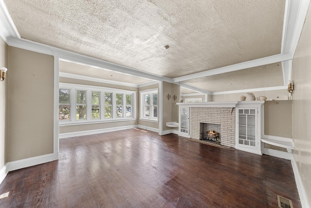 unfurnished living room featuring ornamental molding, a brick fireplace, a textured ceiling, and hardwood / wood-style flooring