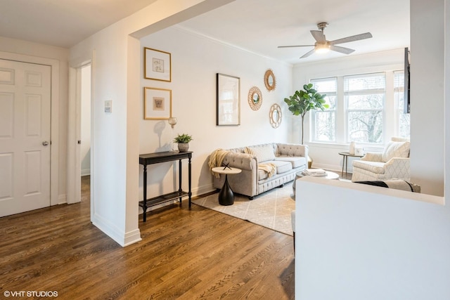 living room with ceiling fan, wood-type flooring, and crown molding