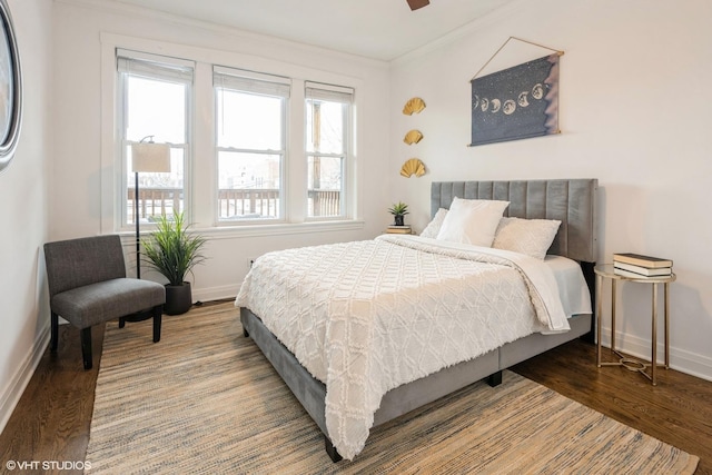 bedroom with ceiling fan, ornamental molding, and hardwood / wood-style flooring