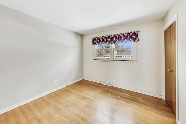 unfurnished room with wood-type flooring