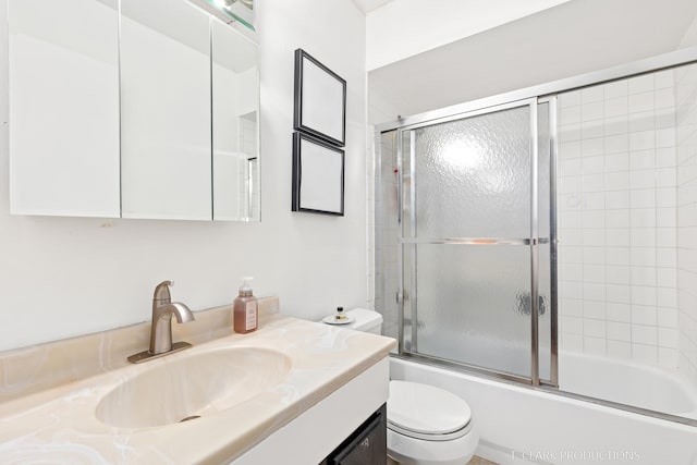 full bathroom with shower / bath combination with glass door, vanity, and toilet