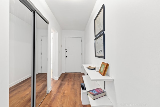 hall with hardwood / wood-style flooring