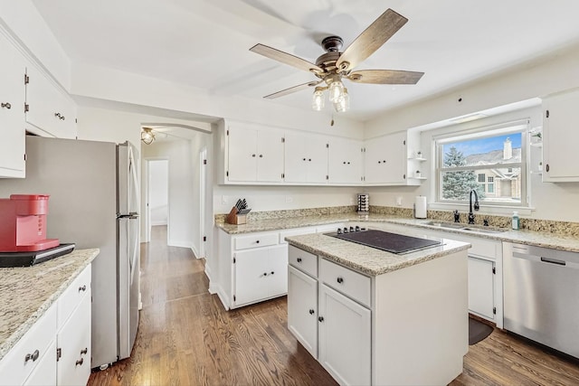 kitchen with white cabinetry, appliances with stainless steel finishes, sink, and a kitchen island