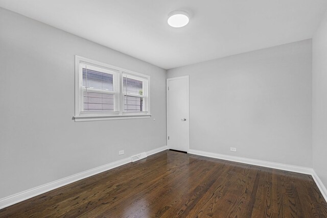 empty room featuring dark wood-type flooring