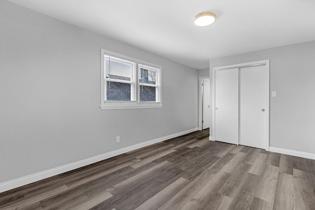 unfurnished bedroom featuring a closet and wood-type flooring