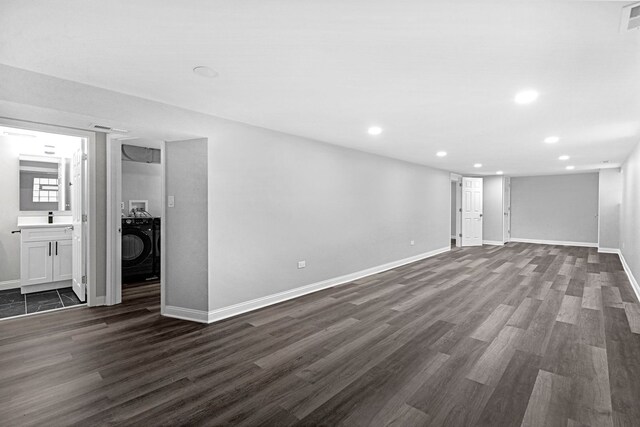 basement featuring washer / clothes dryer and dark hardwood / wood-style floors